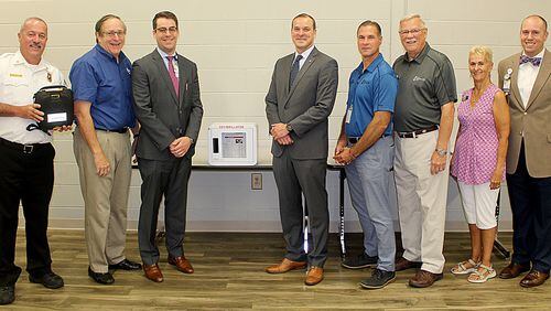 Loganville officials recently accepted a portable AED machine from Eastside Medical Center. (Courtesy Ciity of Loganville)