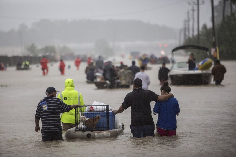 First responders and volunteer rescuers help evacuate people stranded by floodwaters on the outskirts of Houston during Hurricane Harvey on Aug. 28. As part of a multistate effort to respond to damages wrought this year by hurricanes Harvey, Irma and Maria, the University of Houston will lead a new Gulf Coast hurricane research institute. TAMIR KALIFA / THE NEW YORK TIMES