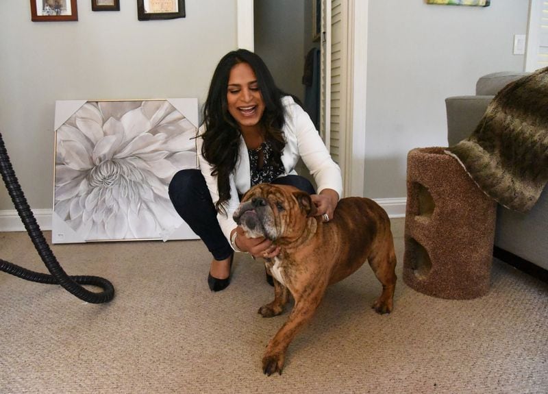 Feroza Syed plays with her dog Teddy at her home in DeKalb County. Until her Feb. 1 Facebook post, most people didn’t know she had started her life as a male. HYOSUB SHIN / HSHIN@AJC.COM