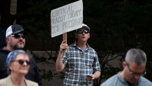 A man holds up a sign during a rally against "critical race theory" (CRT) being taught in schools at the Loudoun County Government center in Leesburg, Va., on June 12, 2021. (Andrew Caballero-Reynolds/AFP via Getty Images/TNS)