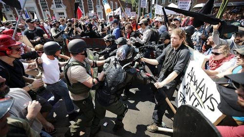 White nationalists, neo-Nazis and members of the alt-right clash with counter-protesters as they enter Lee Park during the ‘Unite the Right’ rally August 12, 2017, in Charlottesville, Va. After clashes with anti-fascist protesters and police the rally was declared an unlawful gathering. CHIP SOMODEVILLA / GETTY IMAGES