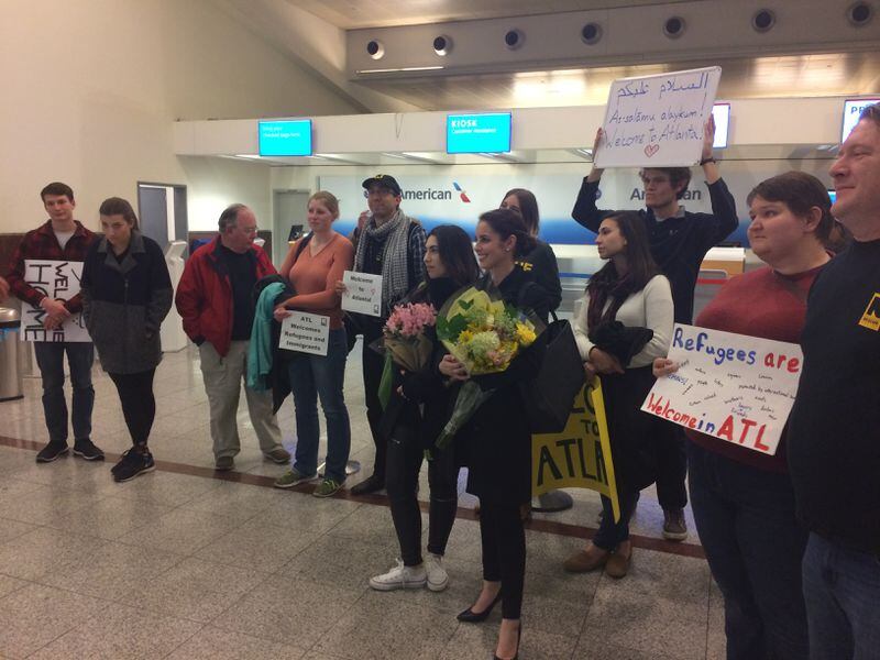 Well wishers, many from the International Rescue Committee in Atlanta, wait for the arrival of a refugee family in Atlanta at Hartsfield Jackson International-Airport Monday night. Photo: Ellen Eldridge