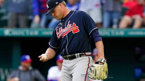 Atlanta Braves starting pitcher Bryce Elder looks at a new ball after giving up a solo home run to Texas Rangers' Corey Seager during the first inning of a baseball game in Arlington, Texas, Saturday, April 30, 2022. (AP Photo/LM Otero)