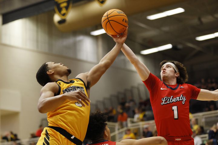 Kennesaw State guard Chris Youngblood (3) fights for a rebound with Liberty Flames guard Darius McGhee (2) during the first at the Kennesaw State Convention Center on Thursday, Feb 16, 2023.
 Miguel Martinez / miguel.martinezjimenez@ajc.com