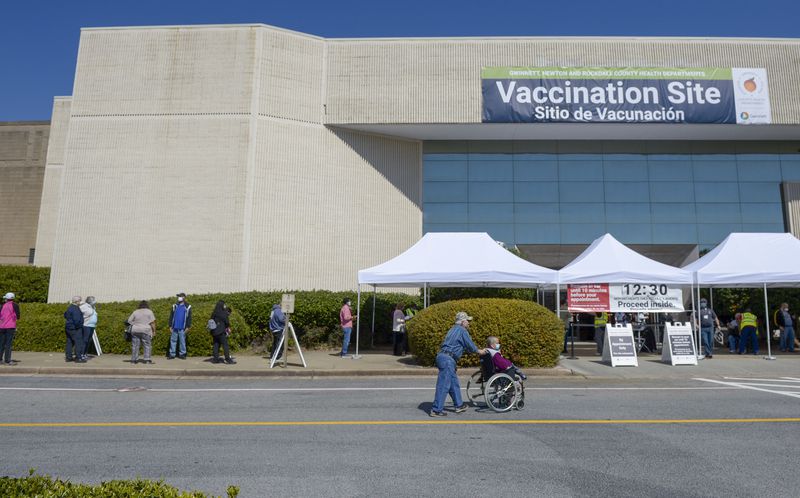 Lines form outside a Gwinnett County vaccination site  at Gwinnett Place Mall in Duluth on March 8, 2021. (Daniel Varnado for the AJC)