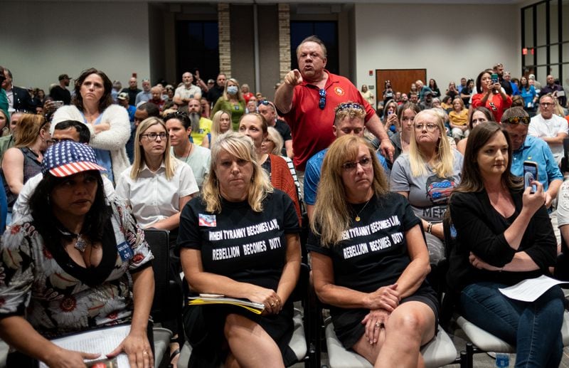 Ron Tripodo, center, yells at the Cherokee County School Board in Canton on May 20, 2021, after they passed a resolution to ban teaching critical race theory and then adjourned the meeting. Tripodo was upset that the language in the resolution was ambiguous. (Credit: Ben Gray for The Atlanta Journal-Constitution