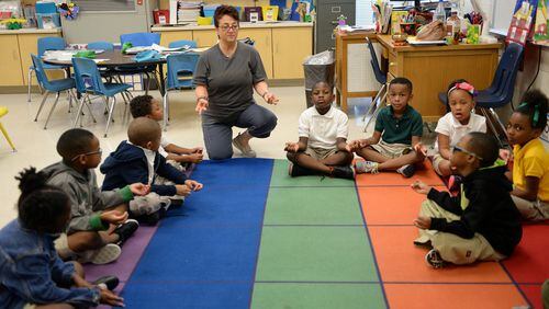 Kindergarten students at Bob Mathis Elementary School do yoga with instructor Sedef Dion in 2017. Students at the school in DeKalb County got yoga as part of their unstructured time during the day. Administrators and teachers said their students exposed to yoga were more focused, and some students themselves found it helps with their classwork. A small but growing number of metro Atlanta schools have embraced yoga, though it triggered litigation in Cobb County, where a lawsuit says Christian parents at one school complained that it endorses a non-Christian belief system. KENT D. JOHNSON / AJC