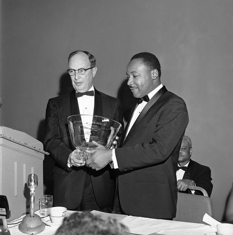 African American integration leader Dr. Martin Luther King Jr., right, winner of the 1964 Nobel Peace Prize, receives a glass bowl inscribed to him as a “citizen of Atlanta, with respect and admiration,” from Rabbi Jacob Rothschild of the Temple Synagogue in Atlanta on Jan. 27, 1965. (AP Photo)