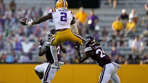 LSU tight end Arik Gilbert (2) tries to pull in a pass against Mississippi State safety Dylan Lawrence (24) and safety Tyrus Wheat. (AP Photo/Gerald Herbert)