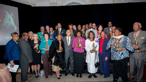 DeKalb County CEO Burrell Ellis named 25 "community heroes" Tuesday night at the annual CEO's award ceremony. Here, Ellis, center in grey, poses with winners.(Credit: DeKalb County)