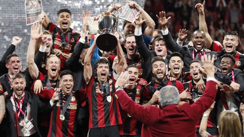 Atlanta United players celebrate winning the MLS Cup 2-0 over the Portland Timbers on Saturday, December 8, 2018, at Mercedes-Benz Stadium in Atlanta. Team owner Arthur Blank is in the foreground. (Photo: BOB ANDRES / BANDRES@AJC.COM)