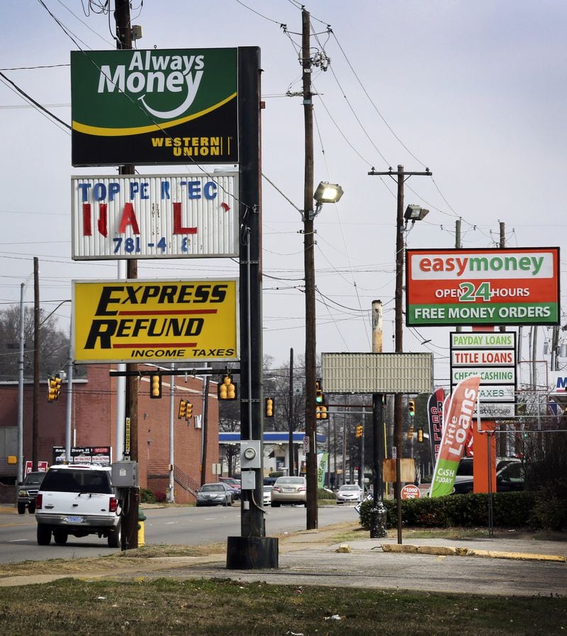 Payday loans are considered so hazardous to consumers that Georgia banned them. Average annual percentage rates can approach 400 percent. Lenders warn borrowers to avoid using them to shoulder long-term debt. Bloomberg photo.