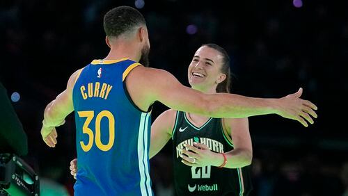 Golden State Warriors guard Stephen Curry hugs New York Liberty guard Sabrina Ionescu after Curry won their competition at the NBA basketball All-Star weekend, Saturday, Feb. 17, 2024, in Indianapolis. (AP Photo/Darron Cummings)