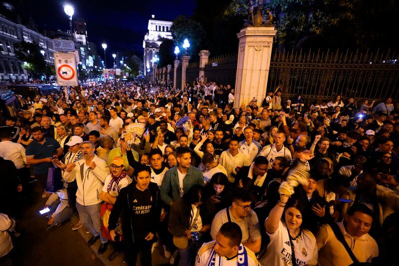 Real Madrid supporters celebrate in Cibeles Square in Madrid after their team clinched the La Liga title, Saturday, May 4, 2024. Real, who had won earlier in the day, clinched the title after Barcelona failed to beat Girona. (AP Photo/Manu Fernandez)