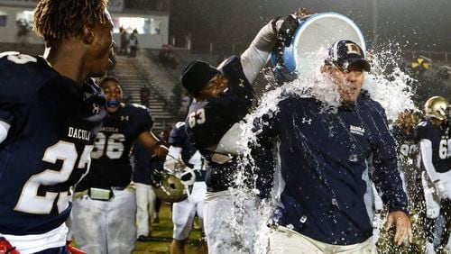 10-26-18 - Dacula, GA - Dacula's Adam Watkins (63) dumps a cooler of ice water on Dacula head coach Clint Jenkins after the end of a high school football game between Lanier and Dacula at Dacula High School in Dacula, Ga., on Friday, Oct. 26, 2018. Dacula blew out Lanier 23-0. (Casey Sykes for The Atlanta Journal-Constitution)