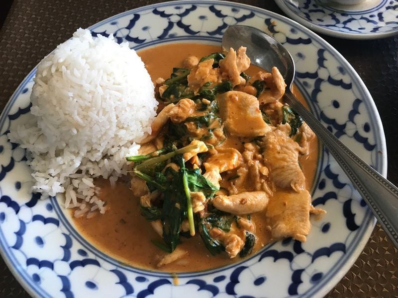 An order of Rama at Zab-E-Lee brings your choice of protein (pictured here is chicken) and spinach in a rich, spicy coconut curry sauce and a garnish of crushed peanuts alongside a serving of white rice. LIGAYA FIGUERAS / LFIGUERAS@AJC.COM