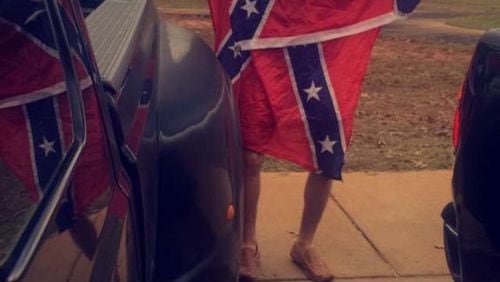 East Coweta High School officials are investigating a photograph of one of their students supposedly wearing a KKK hood.