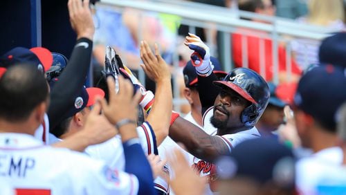 Brandon Phillips (center) of the Braves celebrates a solo home run against the Mets at SunTrust Park on June 10, 2017. (Photo by Daniel Shirey/Getty Images)