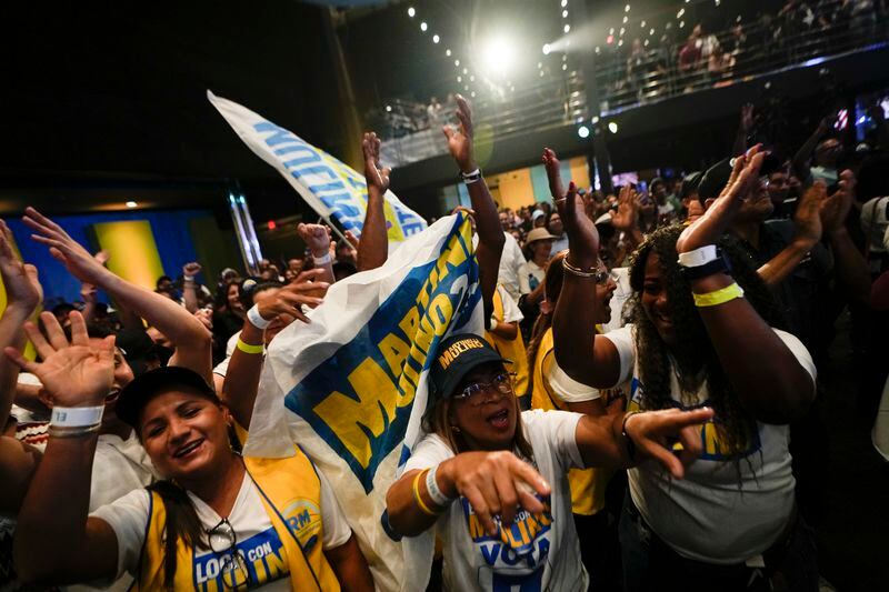 Supporters of Achieving Goals presidential candidate Jose Raul Mulino celebrate early results after the closing of polls for general elections in Panama City, Sunday, May 5, 2024. (AP Photo/Matias Delacroix)