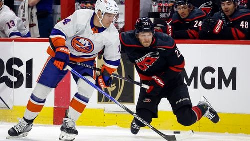 New York Islanders' Bo Horvat (14) collides with Carolina Hurricanes' Brett Pesce (22) during the first period in Game 2 of an NHL hockey Stanley Cup first-round playoff series in Raleigh, N.C., Monday, April 22, 2024. (AP Photo/Karl B DeBlaker)