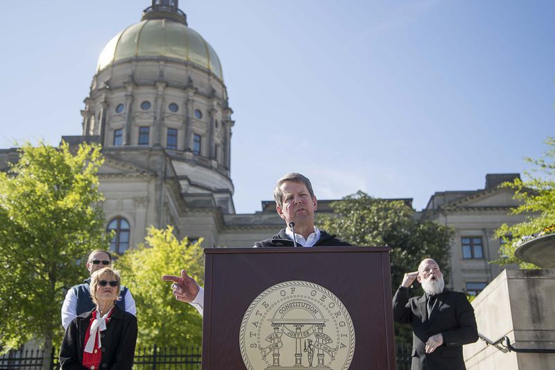 04/01/2020 - Atlanta, Georgia  - Gov. Brian Kemp (center) speaks during a press conference at Liberty Plaza, across the street from the Georgia State Capitol building, in downtown Atlanta, Wednesday, April 1, 2020. During the presser, Gov. Kemp ordered all Georgia K-12 schools to be closed until the end of the academic school year. He also said he will sign an order on Thursday forcing a "Stay-at-home" order for all Georgians until April 13.  (ALYSSA POINTER / ALYSSA.POINTER@AJC.COM)