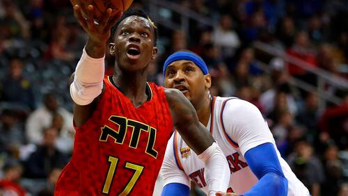 Atlanta Hawks guard Dennis Schroder (17) drives to the basket as he is defended by New York Knicks forward Carmelo Anthony (7) in the first half of an NBA basketball game on Sunday, Jan. 29, 2017, in Atlanta. (AP Photo/Todd Kirkland)