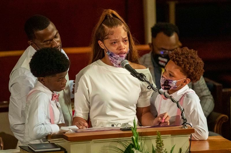 Charmaine Turner, Secoriea's mother, is surrounded by her sons and Secoriea's father, Secoriey Williamson ,while reciting a poem at her daughter's funeral. (ALYSSA POINTER / ALYSSA.POINTER@AJC.COM)