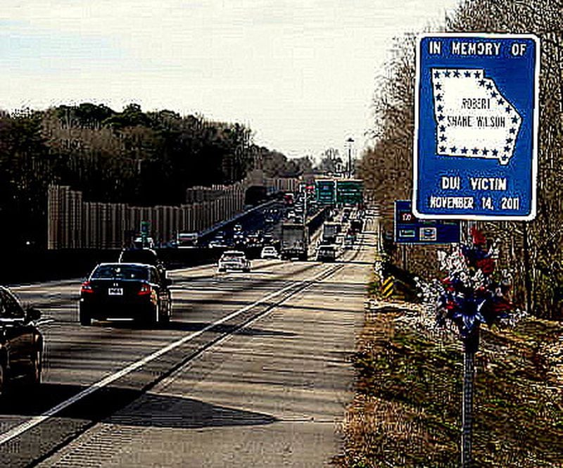 In this file photo, a sign on the the shoulder of the westbound lanes of Interstate 20 near Panola Road commemorates Robert Shane Wilson, a Doraville police officer was answering a call when a driver heading the wrong way on the intersate hit him. Police charged the motorist with driving under the influence.