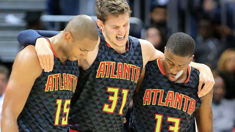 Hawks’ Al Horford (left) and Lamar Patterson (right) help Mike Muscala off the court after he was injured against the Pistrons during the second half in their first regular season basketball game on Tuesday, Oct. 27, 2015 in Atlanta. The Pistons beat the Hawks 106-94. Curtis Compton / ccompton@ajc.com