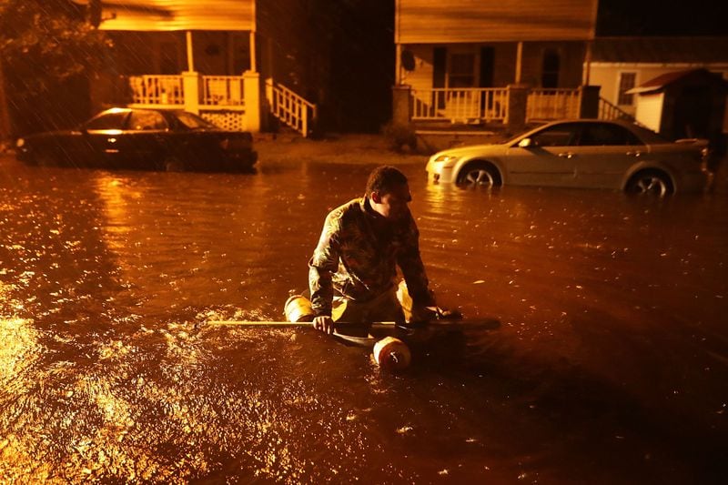  Michael Nelson floats in a boat made from a metal tub and fishing floats after the Neuse River went over its banks and flooded his street during Hurricane Florence Friday  in New Bern, N.C.  (Photo: Chip Somodevilla/Getty Images) 