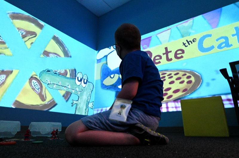 Summer camp participant Harrison plays and learns using technology in sensory room during a summer camp for children with special needs at Lekotek of Georgia in Tucker on Tuesday, July 12, 2022. (Hyosub Shin / Hyosub.Shin@ajc.com)
