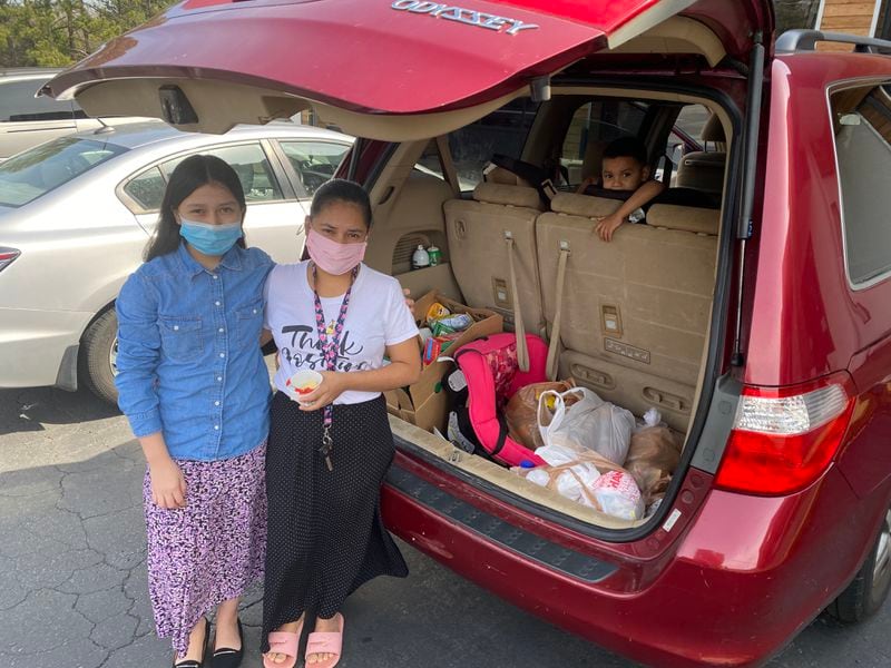 Daisy Rodezno, right, and her niece Zoad picked up food items from the food pantry. Credit: Adrianne Murchison