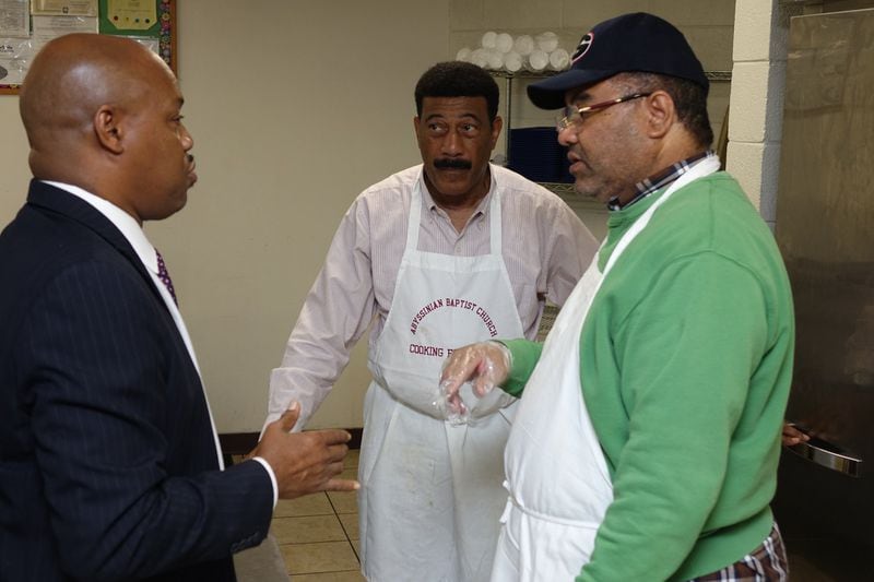 The Rev. Lester Duncan (left), an associate minister at Antioch Baptist Church North, talks with Male Chorus members David Vaughn and Tom Jennings. The Male Chorus helps with the early Thanksgiving dinner that the church prepares for Salvation Army residents. CONTRIBUTED