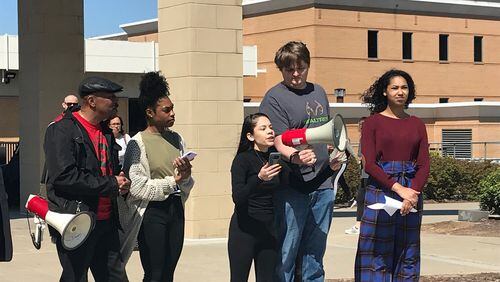 Kennesaw State University student Alexa Vaca, speaking into the bullhorn, addresses supporters and bystanders at a rally on the Kennesaw campus on Thursday demanding administrators do more to prevent racist acts on campus.