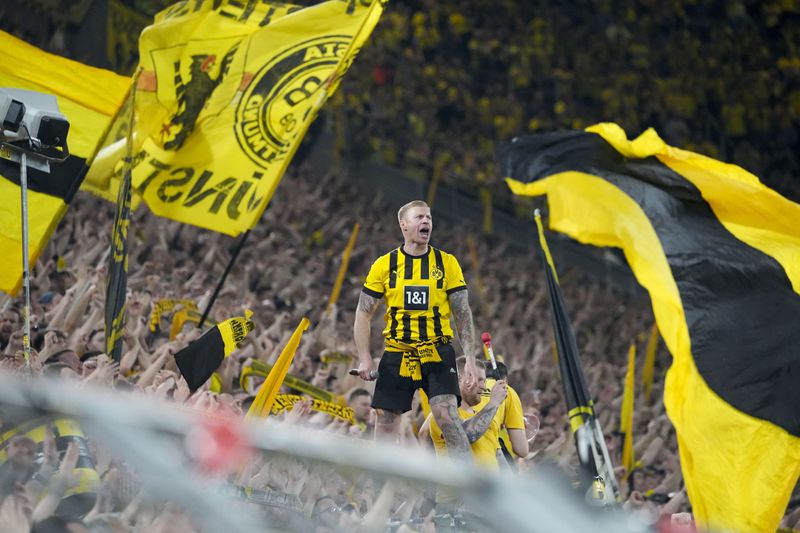 Dortmund's fans cheer for their team during the Champions League semifinal first leg soccer match between Borussia Dortmund and Paris Saint-Germain at the Signal-Iduna Park in Dortmund, Germany, Wednesday, May 1, 2024. (AP Photo/Martin Meissner)