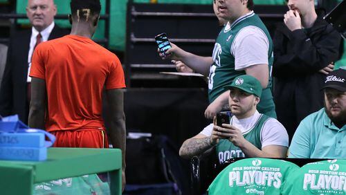 042416 BOSTON: Celtics fans snap photos and sneer at Hawks guard Dennis Schroder as he leaves the court during pregame warmups before playing the Celtics in Game 4 of an NBA basketball first-round playoff series on Sunday, April 24, 2016, in Boston. Schroder and Celtics guard Isaiah Thomas were in a scuffle during game three that resulted in speculation that Thomas could be suspended for a game for contacting Schroder in the head. Curtis Compton / ccompton@ajc.com