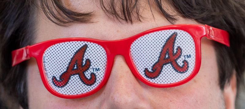 A fan wears Braves glasses before the Braves home opening day game versus the Diamondbacks at Truist Park in Atlanta on Friday, April 5, 2024. (Arvin Temkar / arvin.temkar@ajc.com)