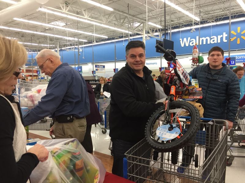  Don Fiechter, a Milton resident, had come in to Wal-Mart to buy dog food. He ended up buying a bike and action figures for a foster kids in need as well. CREDIT: Rodney Ho/rho@ajc.com