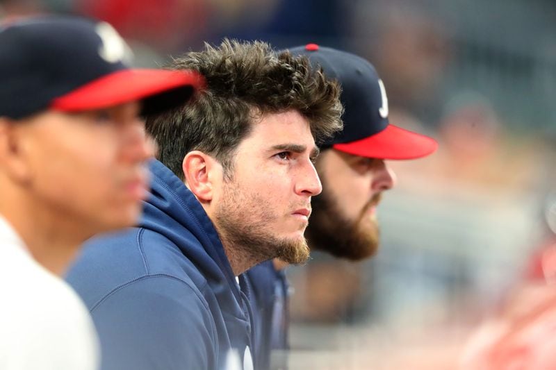 Braves relief pitcher Luke Jackson (center) watches the action from the dugout during the eighth inning in Game 2 of the NLCS Sunday, Oct. 17, 2021, against the Los Angeles Dodgers at Truist Park in Atlanta. (Curtis Compton / curtis.compton@ajc.com)