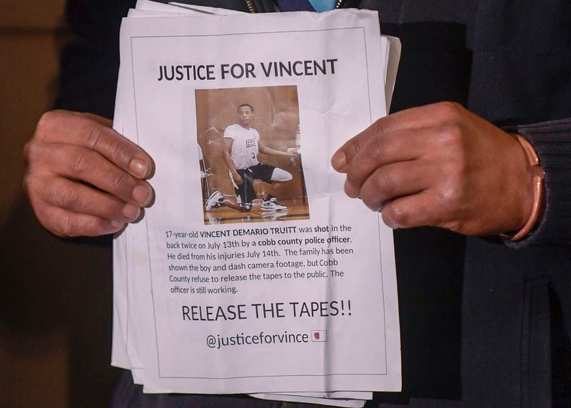 Andre Truitt, Vincent Truitt's father, holds a sign seeking justice for his son.