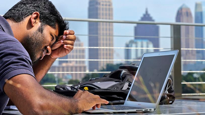 Girish Mururu, 23, a first year masters student in computer science ponders his school work at the G. Wayne Clough Undergraduate Learning Center at Georgia Tech.