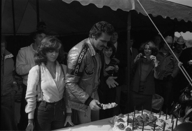 Burt Reynolds' birthday was Feb. 11. On that day in 1980 he was filming "Smokey and the Bandit II" in Atlanta so he and Sally Field and others on the set enjoyed a celebration with birthday cake. AJC archive photo: Jerome McClendon
