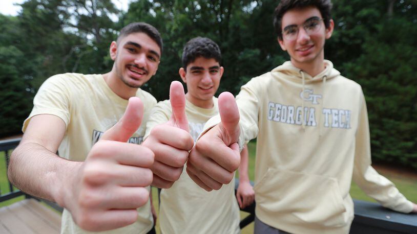 All for one and one for all, the Kashlan triplets Zane (from left), Adam and Rommi are all headed to Georgia Tech, giving the thumbs-up during an interview Tuesday. The brothers were also this year’s valedictorians of West Forsyth High School. CURTIS COMPTON / CCOMPTON@AJC.COM