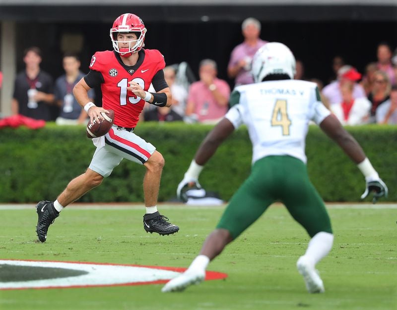 Georgia quarterback Stetson Bennett rolls out to pass against UAB during the first quarter Saturday, Sept 11, 2021, at Sanford Stadium in Athens. (Curtis Compton / Curtis.Compton@ajc.com)