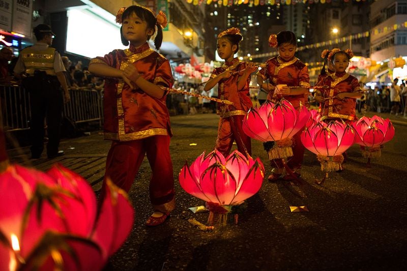 HONG KONG - SEPTEMBER 08: Residents of Tai Hang perform the Fire Dragon Dance to celebrate the Mid-Autumn Festival in Tai Hang area on September 8, 2014 in Hong Kong, China. In the 19th century the people in the village of Tai Hang miraculously stopped a plague with a fire dragon dance. It has become a annual tradition, where up to 300 performers dance the fire dragon, which is made up of 72,000 sticks of buring incense and a 67 mtr long dragon through the narrow streets of Tai Hang. (Photo by Lam Yik Fei/Getty Images)