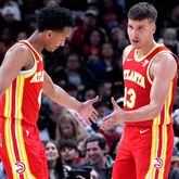 Atlanta Hawks guard Bogdan Bogdanovic, right, celebrates with guard Kobe Bufkin after scoring a basket during the second half of an NBA basketball game against the Chicago Bulls in Chicago, Monday, April 1, 2024. (AP Photo/Nam Y. Huh)