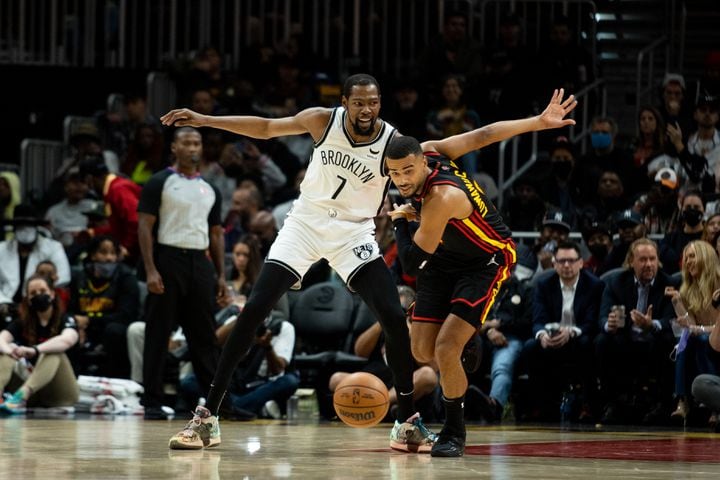 The Hawks' John Collins (20) guards the Nets' Kevin Durant (7) during a game between the Atlanta Hawks and the Brooklyn Nets at State Farm Arena in Atlanta, GA., on Friday, December 10, 2021. (Photo/ Jenn Finch)