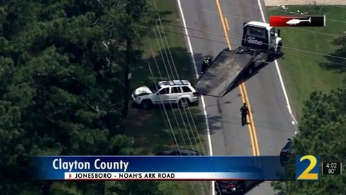 A 12-year-old boy and his caregiver were hit by a car Friday morning after the child ran into a busy Clayton County road, police said.