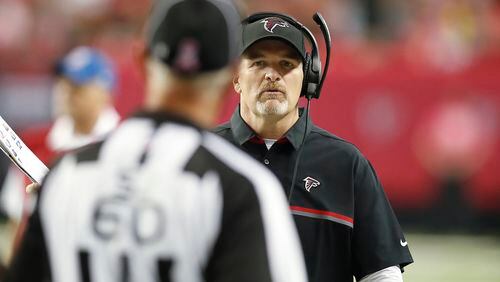Atlanta Falcons head coach Dan Quinn speaks with side judge Gary Cavaletto (60) during the second half of an NFL football game against the San Diego Chargers, Sunday, Oct. 23, 2016, in Atlanta. (AP Photo/John Bazemore)
