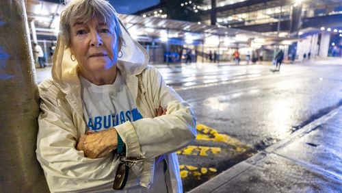 Grannies Respond volunteer Joan Dewitt poses for a photograph outside the Greyhound bus station early Saturday morning in Atlanta, Mar. 25, 2023. (Steve Schaefer/steve.schaefer@ajc.com)